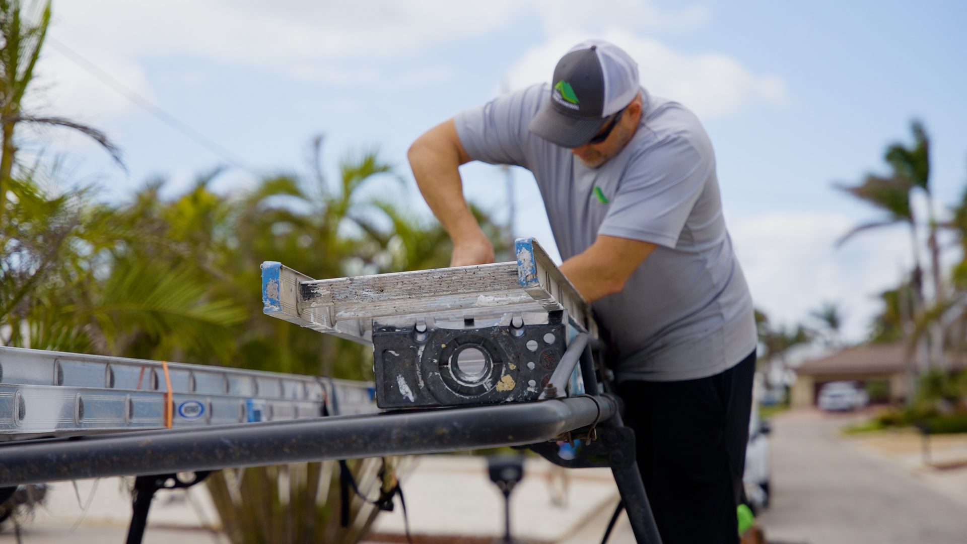Florida Roof Renewal crew member unloading equipment