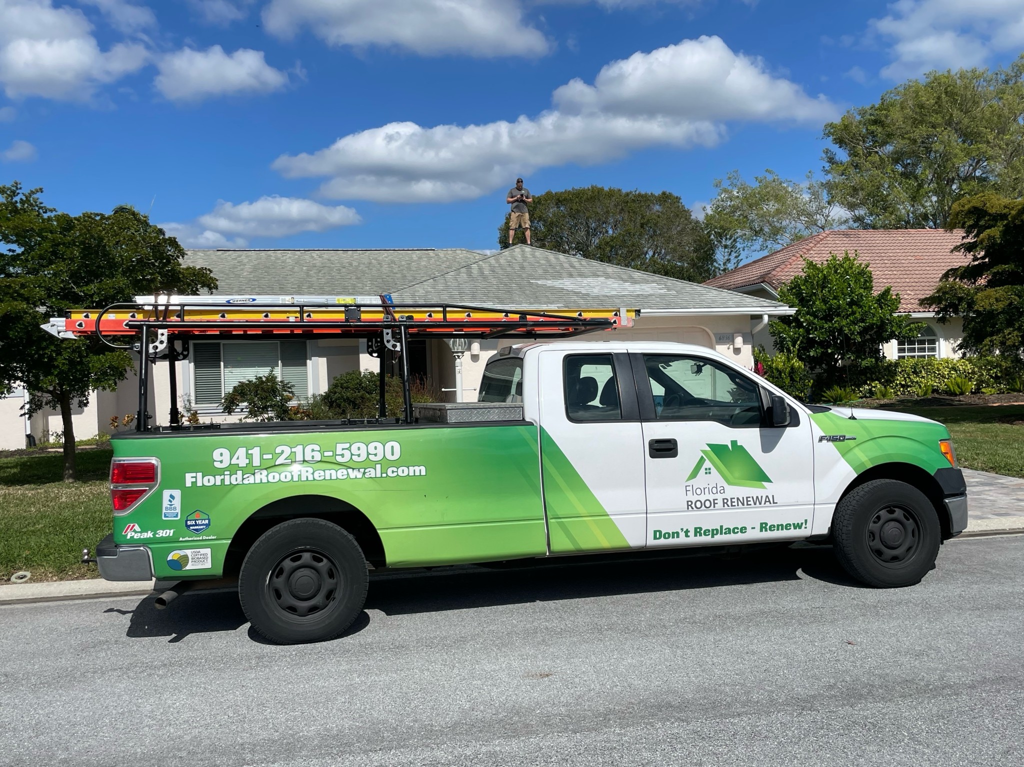 Residential roof after acrylic coating application showing reflective white surface