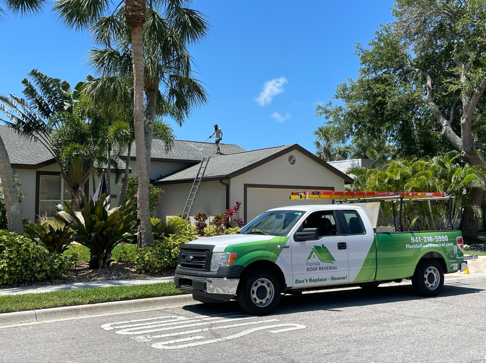 Florida Roof Renewal truck parked at an active rejuvenation job site