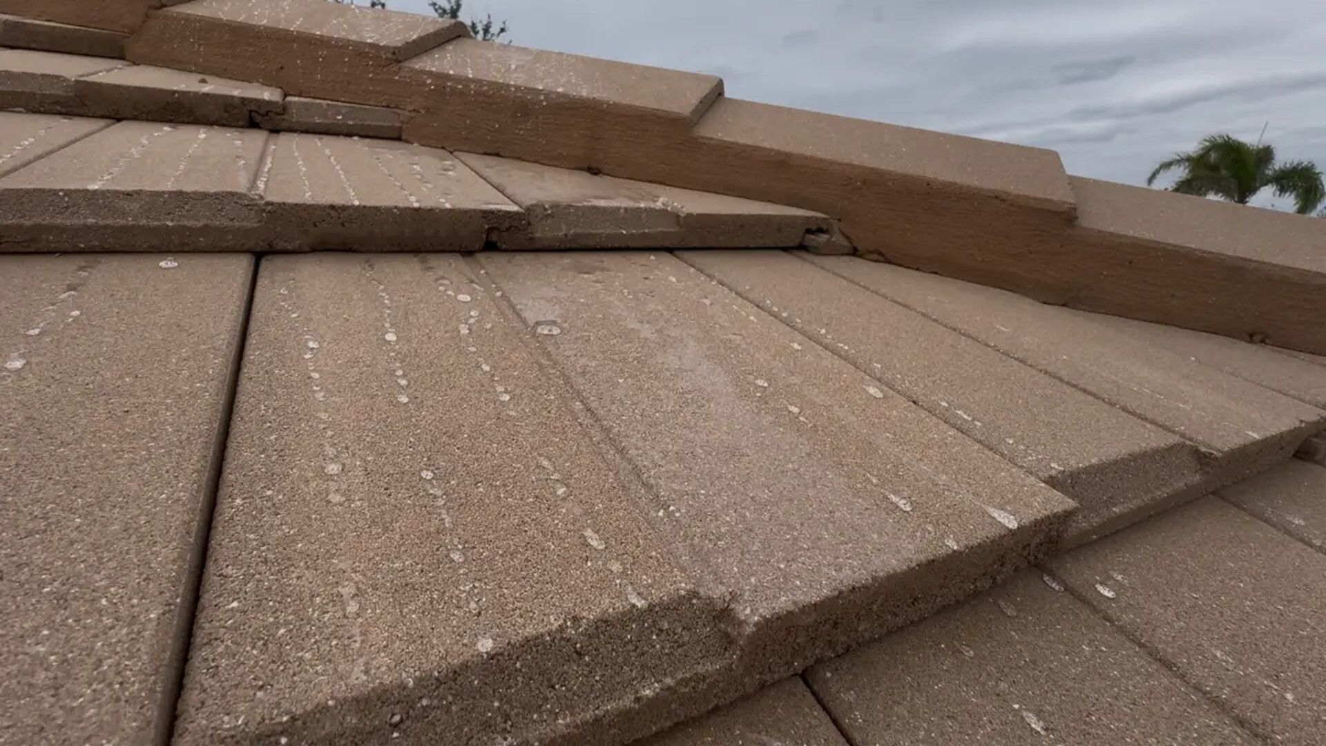 Tile roof sealer being applied to clay tile roof surface